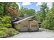 Home exterior showcasing an attached two-car garage, with green trees on the lot at 1604 Pinecrest Rd, Durham, NC 27705
