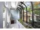 Bright hallway with unique glass features and a built in planter box at 1604 Pinecrest Rd, Durham, NC 27705
