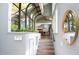 Bright hallway with unique glass features and a stairway leading to the next level at 1604 Pinecrest Rd, Durham, NC 27705