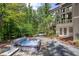 Exterior view of hot tub on backyard patio with mature hardwood trees at 1604 Pinecrest Rd, Durham, NC 27705