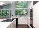 Bright kitchen featuring ample natural light from expansive windows and modern appliances at 1604 Pinecrest Rd, Durham, NC 27705