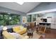 Spacious living room with open kitchen concept, bright windows, and modern decor at 1604 Pinecrest Rd, Durham, NC 27705