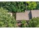 An aerial view of the home nestled in a tree-filled landscape showing the roof and front yard at 17 Crystal Oaks Ct, Durham, NC 27707