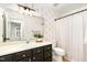 Updated bathroom featuring stylish wallpaper, a vanity, and shower with curtain at 17 Crystal Oaks Ct, Durham, NC 27707