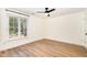Bedroom featuring wood-look floors, a ceiling fan, and a window providing natural light at 17 Crystal Oaks Ct, Durham, NC 27707