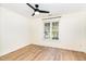 Bedroom featuring wood-look floors, a ceiling fan, and a window providing natural light at 17 Crystal Oaks Ct, Durham, NC 27707