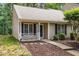 Inviting home exterior with charming front porch, manicured landscaping, and neutral siding at 17 Crystal Oaks Ct, Durham, NC 27707
