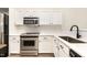 Kitchen with white cabinets, stainless steel appliances, and ample countertop space with a sink at 17 Crystal Oaks Ct, Durham, NC 27707
