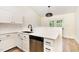Updated kitchen with white cabinets, quartz countertops, stainless steel appliances, and matte black hardware at 17 Crystal Oaks Ct, Durham, NC 27707