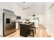 Modern kitchen with stainless steel appliances, white cabinets, an island, and stylish pendant lighting at 17 Crystal Oaks Ct, Durham, NC 27707
