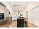 Well-lit kitchen featuring stainless steel appliances, an island, and modern lighting fixtures at 17 Crystal Oaks Ct, Durham, NC 27707