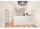 Open-concept living area showcasing modern lighting, wood-look floors, and a bright kitchen at 17 Crystal Oaks Ct, Durham, NC 27707