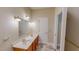 Bright bathroom features a double sink vanity with oak cabinets and tiled floors at 20 Banbury Ct, Roxboro, NC 27573