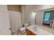 Bright bathroom features a tile floor, shower with curtain, and a vanity at 20 Banbury Ct, Roxboro, NC 27573