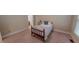 Cozy bedroom with neutral walls, carpet flooring, and furnishings including a bed with a blue pillow at 20 Banbury Ct, Roxboro, NC 27573