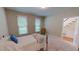 Bright bedroom featuring carpet flooring, two windows and furnishings including a bed and chair at 20 Banbury Ct, Roxboro, NC 27573