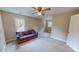 Spacious bonus room featuring tan walls, neutral carpet, and a comfortable plaid couch at 20 Banbury Ct, Roxboro, NC 27573