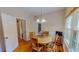 Cozy dining area with wooden table, chairs, and a view into the living room with brick fireplace at 20 Banbury Ct, Roxboro, NC 27573