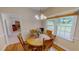 Charming dining area featuring a wooden table with decorative flowers, a window with blinds and hardwood floors at 20 Banbury Ct, Roxboro, NC 27573