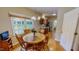 Bright dining area with wood floors and a view to the kitchen features a round wooden table and chairs at 20 Banbury Ct, Roxboro, NC 27573