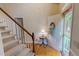 Welcoming entryway with staircase, wood floors, and a decorative wreath, creating a warm and inviting space at 20 Banbury Ct, Roxboro, NC 27573