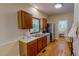 Functional kitchen with wood cabinets, stainless steel appliances, and view into the laundry area at 20 Banbury Ct, Roxboro, NC 27573