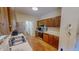 Functional kitchen with wooden cabinetry, stainless appliances, and hardwood flooring for easy maintenance at 20 Banbury Ct, Roxboro, NC 27573