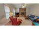 Cozy living room features a brick fireplace, carpeted floors, and natural light from a large window at 20 Banbury Ct, Roxboro, NC 27573