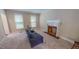 Bright living room with a brick fireplace and neutral-toned carpet, ideal for relaxation and gatherings at 20 Banbury Ct, Roxboro, NC 27573