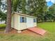 Backyard shed with a ramp in a grassy yard at 20 Banbury Ct, Roxboro, NC 27573