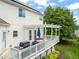 Elevated wooden deck featuring a pergola, outdoor seating, a grill, and scenic views of the backyard and surroundings at 2000 Katesbridge Ln, Raleigh, NC 27614