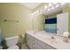 Bathroom with dual sinks, large mirror, and blue shower curtain in the background at 2000 Katesbridge Ln, Raleigh, NC 27614
