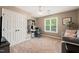 Bedroom features neutral decor, a large window for natural light, and a closet with mirrored doors at 2000 Katesbridge Ln, Raleigh, NC 27614