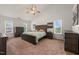 Spacious bedroom with a ceiling fan, carpet flooring, and plenty of natural light from the windows at 2000 Katesbridge Ln, Raleigh, NC 27614