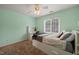 Comfortable bedroom with a desk, closet, a ceiling fan, and a bright window to create a private and relaxing retreat at 2000 Katesbridge Ln, Raleigh, NC 27614
