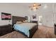 An inviting bedroom boasts a ceiling fan, bedside tables, artwork, and an ensuite bathroom, adding convenience and style at 2000 Katesbridge Ln, Raleigh, NC 27614