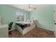 Bedroom with carpet flooring, ceiling fan, desk and large window offering natural light at 2000 Katesbridge Ln, Raleigh, NC 27614