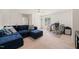 This bonus room features a cozy blue couch, work area, and natural light at 2000 Katesbridge Ln, Raleigh, NC 27614