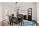 Elegant dining room with a modern chandelier and glass-top table with seating for six at 2000 Katesbridge Ln, Raleigh, NC 27614