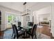 Elegant dining room featuring a glass-top table, black chairs, modern lighting, and an open layout at 2000 Katesbridge Ln, Raleigh, NC 27614