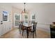 Bright dining area with tiled floors, chandelier and multiple windows at 2000 Katesbridge Ln, Raleigh, NC 27614