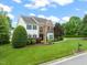 Beautifully landscaped front yard featuring a stately brick and siding home at 2000 Katesbridge Ln, Raleigh, NC 27614