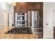 Modern kitchen featuring stainless steel appliances, granite countertops, and dark wood cabinetry at 2000 Katesbridge Ln, Raleigh, NC 27614