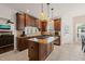Gourmet kitchen with a center island, stainless steel appliances, dark wood cabinetry, and ample counter space at 2000 Katesbridge Ln, Raleigh, NC 27614