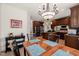 Open-concept kitchen and dining area with dark wood cabinets and stainless steel appliances at 2000 Katesbridge Ln, Raleigh, NC 27614