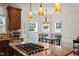 Well-lit kitchen with granite counters, gas range, and a breakfast nook by the windows at 2000 Katesbridge Ln, Raleigh, NC 27614