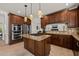 Spacious kitchen features wood cabinets, a gas range, stainless steel appliances, and tile floors at 2000 Katesbridge Ln, Raleigh, NC 27614