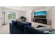 Bright living room features a large window and a modern entertainment center beneath a wall-mounted television at 2000 Katesbridge Ln, Raleigh, NC 27614