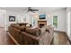 Spacious living room features a cozy fireplace and large, comfortable brown sectional sofa at 2000 Katesbridge Ln, Raleigh, NC 27614