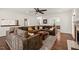 Bright living room with a large comfortable sectional sofa, hardwood floors, and neutral colored rug at 2000 Katesbridge Ln, Raleigh, NC 27614